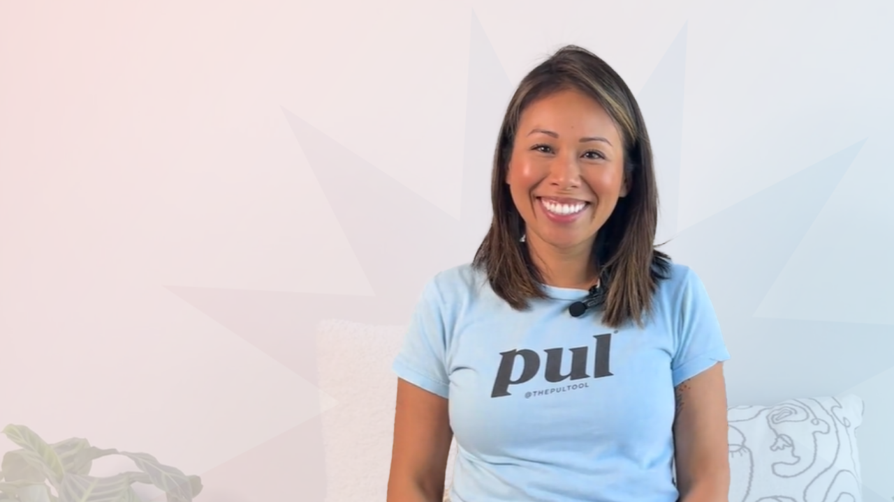 Jannet Ly, Co-founder and Registered Dental Assistant smiles at camera wearing blue branded PUL tshirt